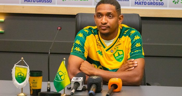 Atacante Hernandes durante coletiva de apresentação no Cuiabá Esporte Clube, vestindo a camisa auriverde na sala de imprensa.