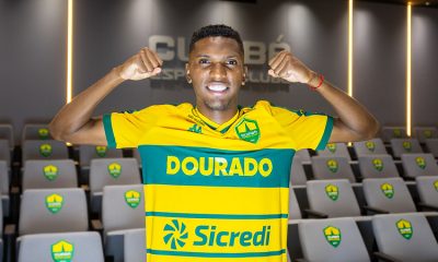 Vinícius Peixoto posa com a camisa do Cuiabá EC no auditório do clube durante sua apresentação oficial como reforço.