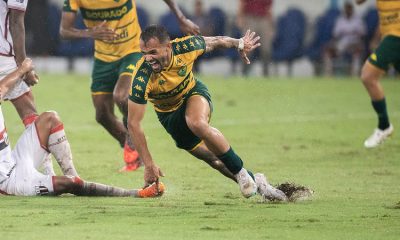 Jogador do Cuiabá disputa bola sob chuva intensa durante jogo contra o Botafogo-SP na Arena Pantanal pela Série B