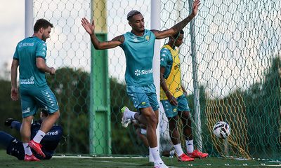 Atacante Derik Lacerda, do Cuiabá, durante treino no CT Manoel Dresch, com os braços erguidos próximo ao gol, em preparação para partida pela Série B.