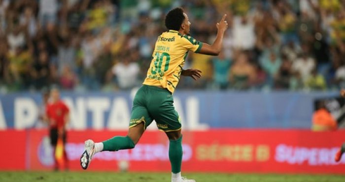 Lucas Mineiro., celebra um gol correndo em direção à torcida, apontando para o alto com o dedo indicador.